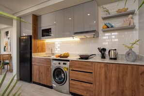 Microwave, electric kettle, cookware/dishes/utensils, dining tables