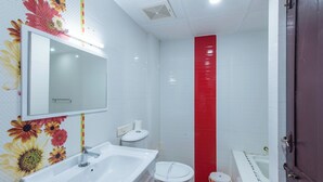 A bathroom with a white sink, toilet, and bathtub. - Atreya Ayurveda & Yoga Beach Retreat  (Kovalam)