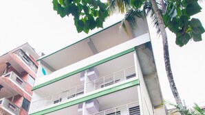 A multi-story building with a sign for 'Atreja Ayurveda & Yoga Beach Retreat'. - Atreya Ayurveda & Yoga Beach Retreat  (Kovalam)