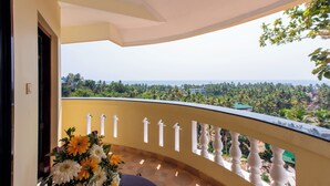 A balcony with a view of a green landscape and a distant horizon. - Atreya Ayurveda & Yoga Beach Retreat  (Kovalam)