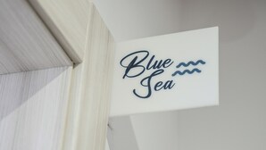 A sign with the text "Blue Sea" and a wavy line symbol. - BlueB&B (Pagani)