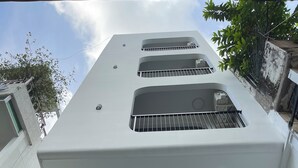 A modern building with multiple balconies, a flat roof, and a metal railing. - Unite StayCation Le Van Sy (Ho Chi Minh City)