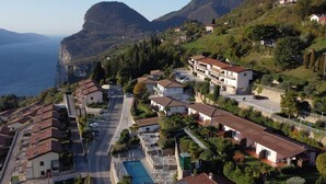A coastal residential area with houses, a swimming pool, and a road leading to the sea. - Piccola Italia by Interhome (Tremosine)