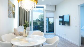 Deluxe Apartment, Balcony, Park View | Living area | 90-cm flat-screen TV with digital channels, heated floors