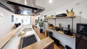 A modern kitchen with a central island, stainless steel range hood, and built-in appliances. - Villa for rent for up to 10 people [Antiques Gifu Station East] 10 min. walk from JR Gifu Station (岐阜市)