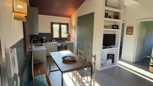Eine moderne Küche mit Essbereich, Einbauherd und Fenster für natürliches Licht.