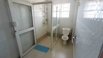 Family Apartment, City View | Bathroom | Shower, slippers, towels, soap