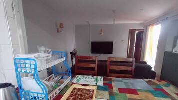 Deluxe Apartment | Living area | 32-inch Smart TV with digital channels