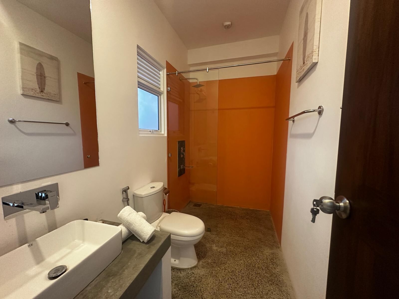 A bathroom with a toilet, sink, and shower.