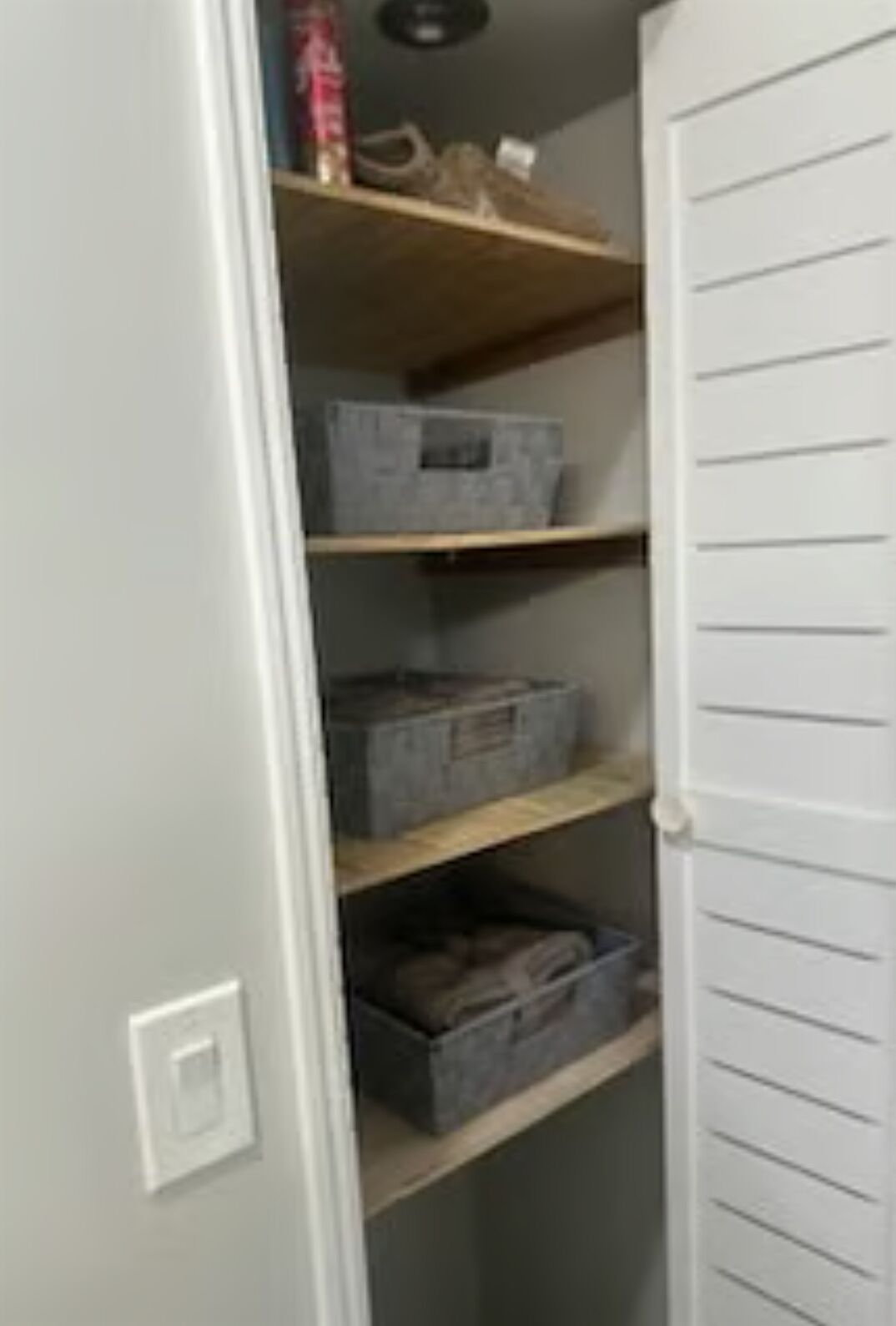 A storage closet with shelves and boxes.
