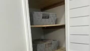A storage closet with shelves and boxes.