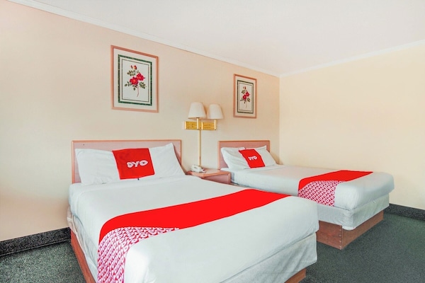 Recharge together with two comfy beds and shared nightstand.