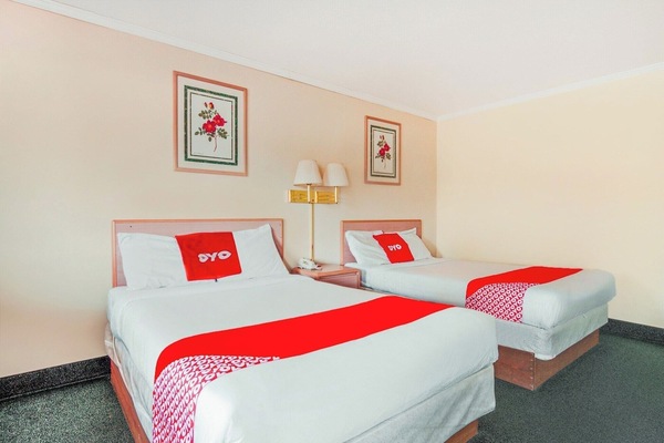 Recharge together with two comfy beds and shared nightstand.