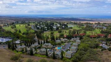 A residential area with houses, a swimming pool, and a golf course.