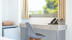 A room with a desk, a chair, a telephone, and a window with curtains. - AIRSCAPE HOTEL FREE SHUTTLE ATH AIRPORT (Spata-Artemida)