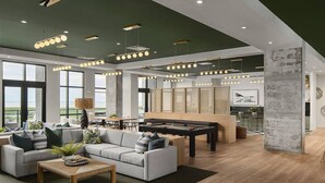 A spacious living area with a pool table, a sofa set, and a dining area. - Landing | Beautiful 2BD, Gym (St. Petersburg)
