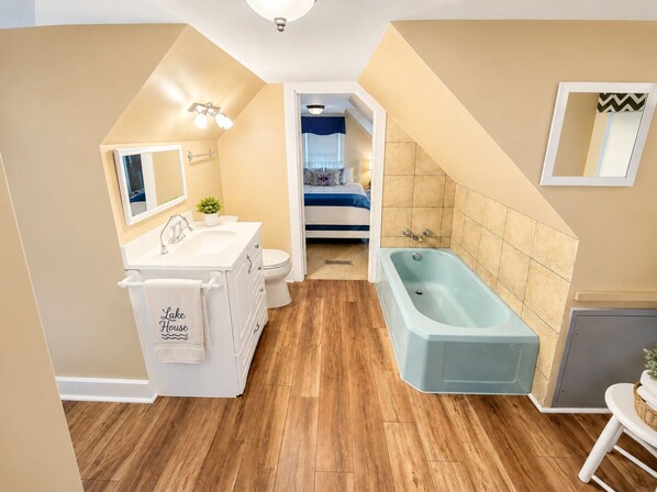 A modern bathroom with a freestanding bathtub, a sink, and a toilet.
