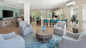A spacious living room with patterned sofas, a coffee table, and a TV. - Landing | Stunning 2BD, Gym, Clubhouse (Charlotte)