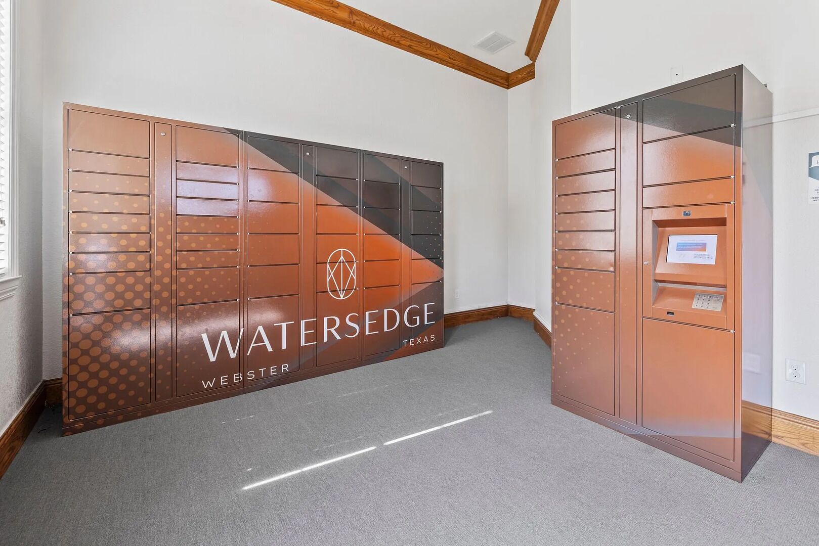 A Watersedge Webster, Texas restroom with a modern design, featuring a large mirror, a sink, and a toilet.