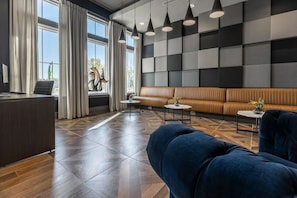 A modern lobby with a reception desk, seating area, and large windows. - Landing | Stunning 2BD, Clubhouse, Gym (Murfreesboro)