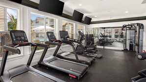 A gym with treadmills, weight machines, and a large mirror. - Landing | Stylish 2BD, Gym (Monroe)