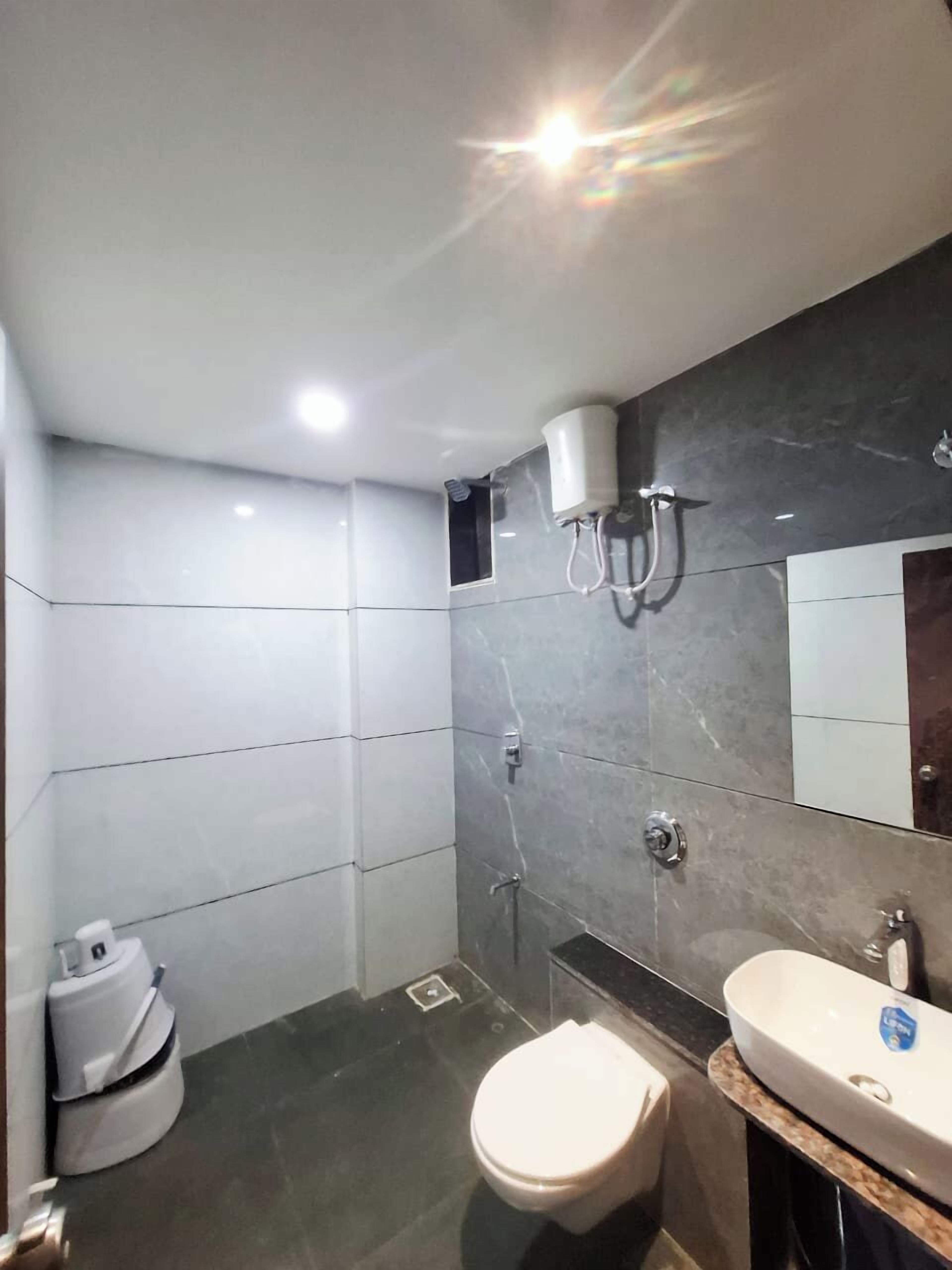 A modern bathroom with a toilet, bidet, and sink.