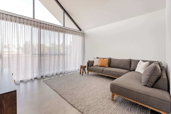 Tucked into the front left wing, this second living area offers a quiet, light-filled space for reading or relaxed conversation.