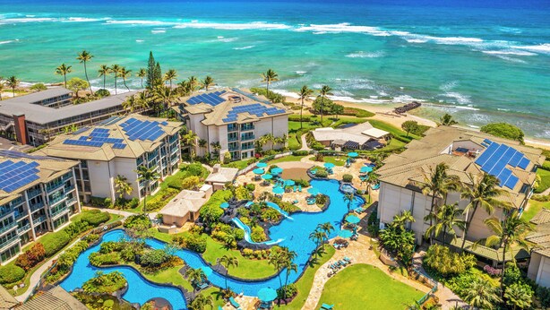A resort with multiple buildings, a swimming pool, and a view of the ocean. - Fall Getaway at Oceanfront Waipouli Beach Resort (Kapaʻa)