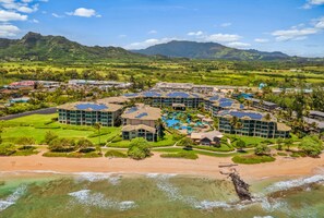 Et resort med flere bygninger, en swimmingpool og en strand.