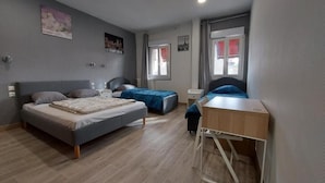 A bedroom with two beds, a desk, and a window. - ARDENN HOTEL (Reims)