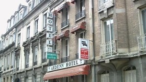 A hotel with a prominent sign, multiple balconies, and a classic architectural style. - ARDENN HOTEL (Reims)