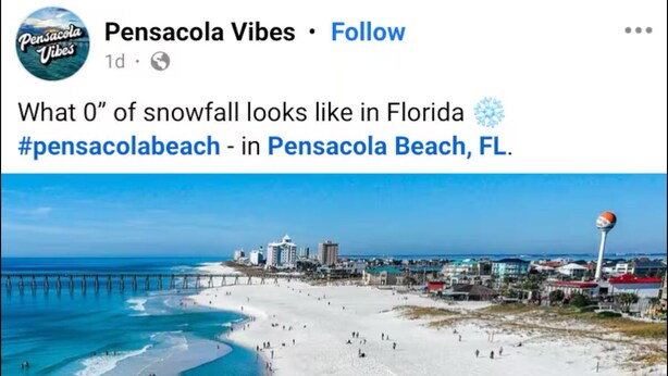 A beach with clear turquoise water, white sand, and a pier in the background.