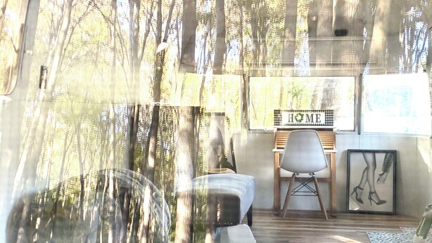 Una habitación con una cama, una silla, un escritorio y un letrero en la pared que dice 'HOME'.
