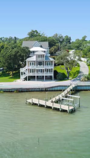 A waterfront property with a large house, a dock, and a pathway leading to the house. - Waterfront home with ocean views and walk to Downtown Swansboro (Swansboro)