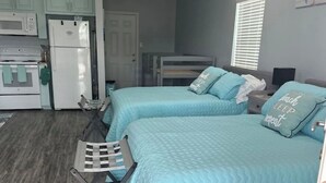 A compact room with two beds, a kitchenette, and a ceiling fan. - BB On The Bayou  (Gautier)