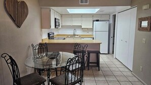 A compact kitchen with a central island, white cabinets, and a heart-shaped decoration on the wall. - NEW LOW RATE FOR THE SUMMER!                3-bed 2-bath townhome in Tempe (Tempe)