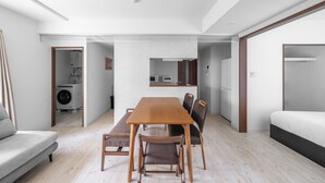 A modern, open-plan living space with a dining area, kitchenette, and a separate sleeping area. - OTARU SAMPO 2 (Otaru)