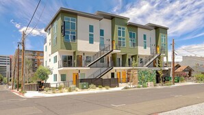 A modern multi-story residential building with a flat roof, large windows, and a central staircase. - Reno`s Downtown and Midtown Getaway (Reno)
