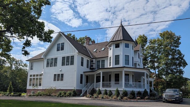 A large, two-story house with a wrap-around porch, a chimney, and a car parked in front. - Parkway House Goshen Bed & Breakfast Suite #2 (Goshen)