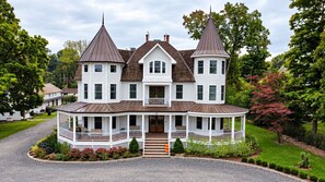 A large, two-story house with a wrap-around porch and two towers. - Parkway House Goshen Bed & Breakfast Suite #2 (Goshen)