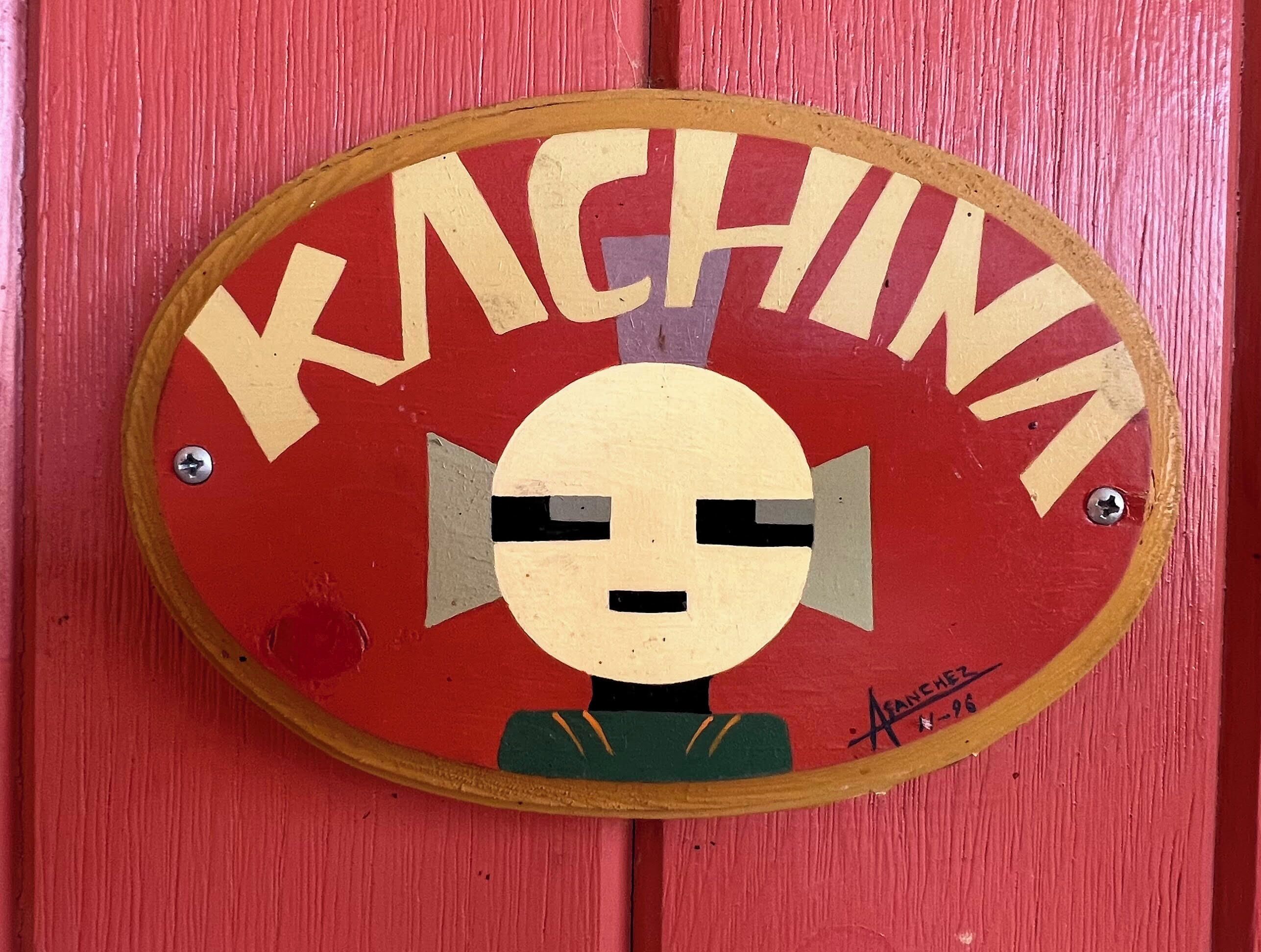 A red sign with the word "KACHINA" and a stylized face design.
