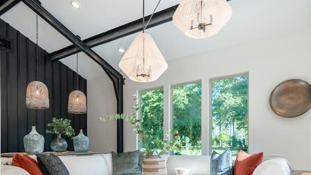 A modern living room with white sofas, a wooden coffee table, and hanging pendant lights. - Luxury Getaway in East Texas, Pool • Jacuzzi (Bullard)