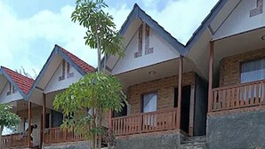 A residential area with houses featuring balconies and a paved driveway. - Griya Prasetaya (Wonosari)