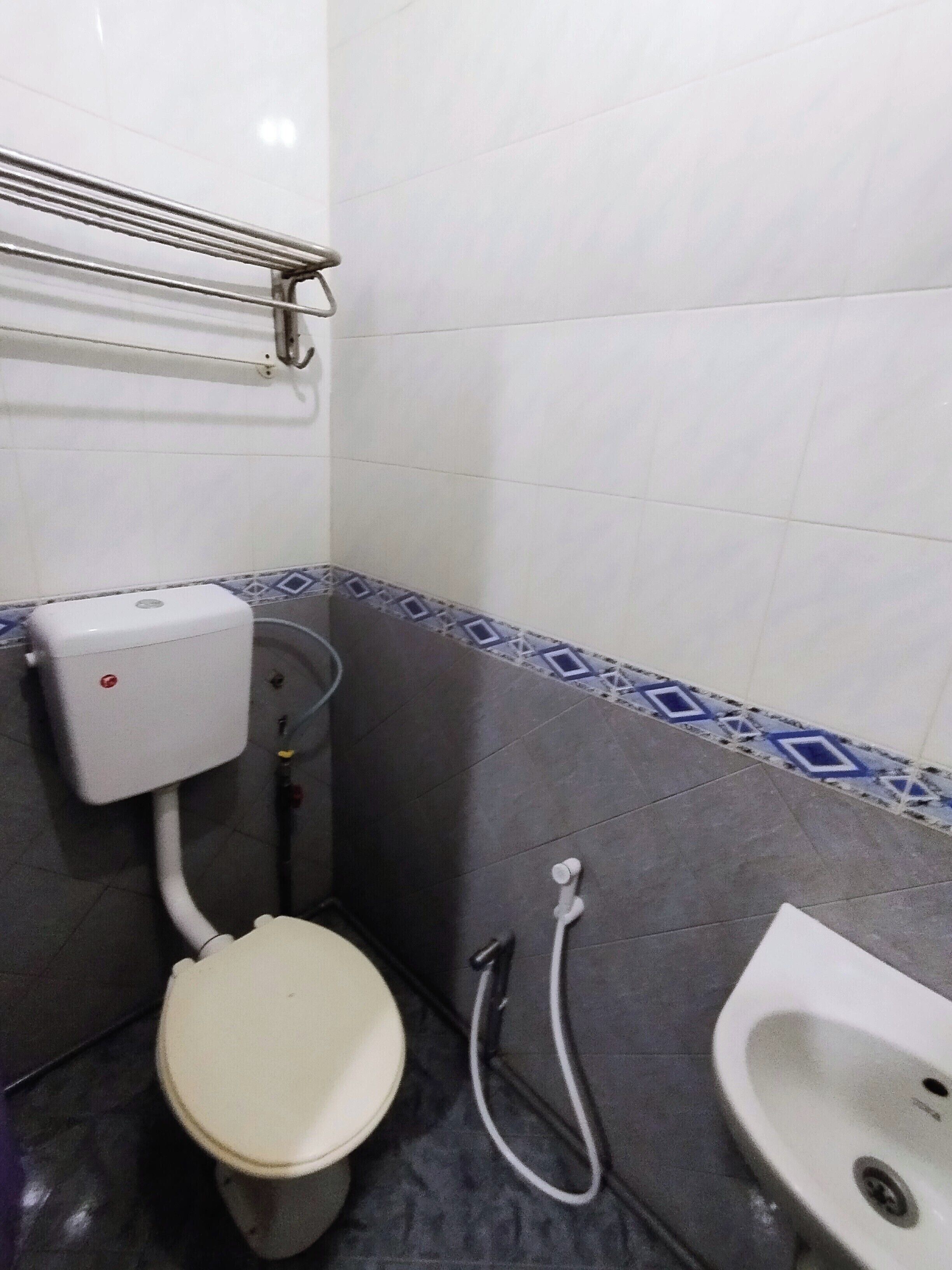 A small bathroom with a toilet, bidet, and sink.