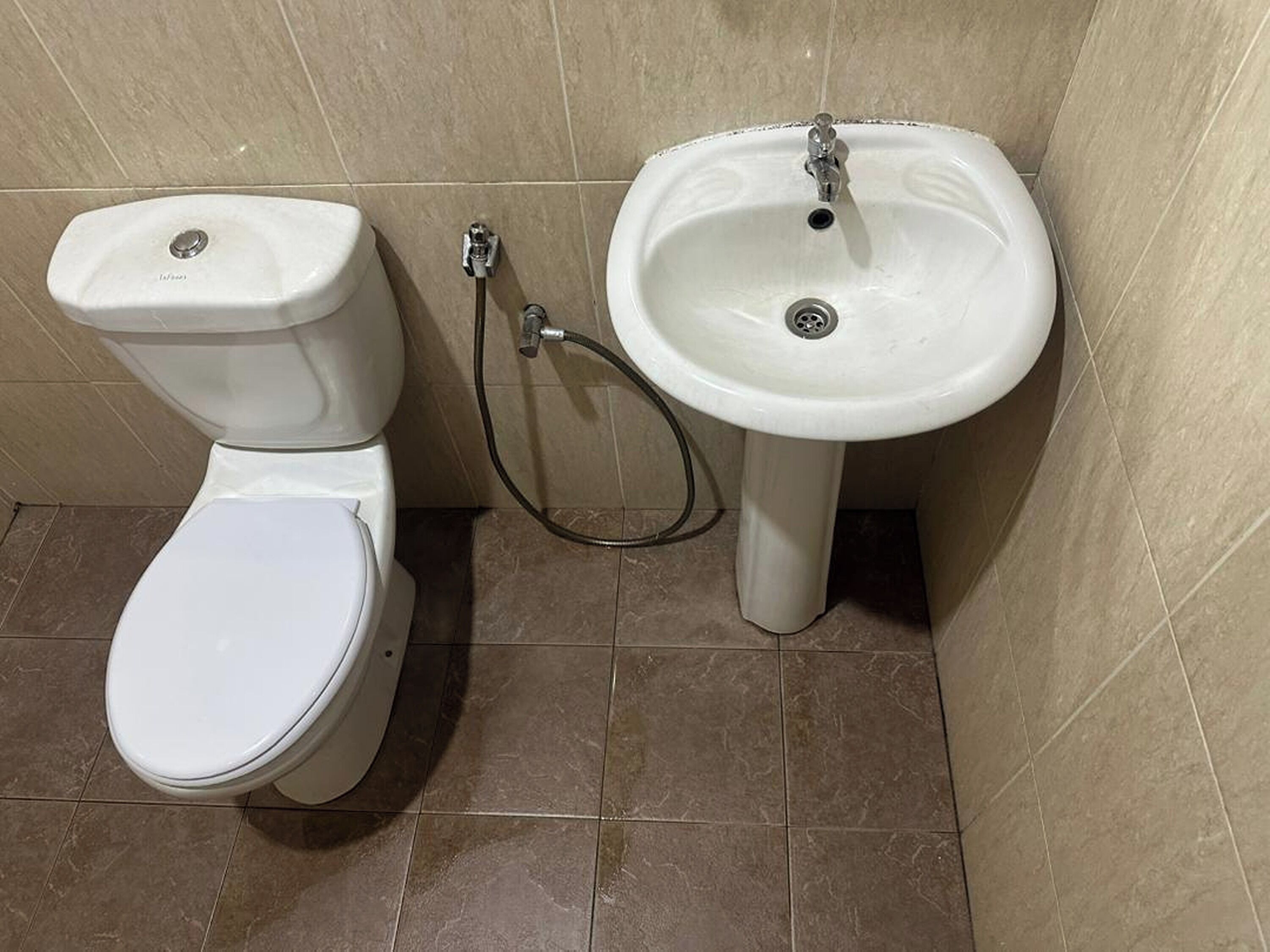 A bathroom with a toilet and a sink.