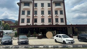 A hotel building with multiple floors, air conditioning units, and a large sign reading "GLISTAR HOTEL". - Glistar Hotel (Tampin)