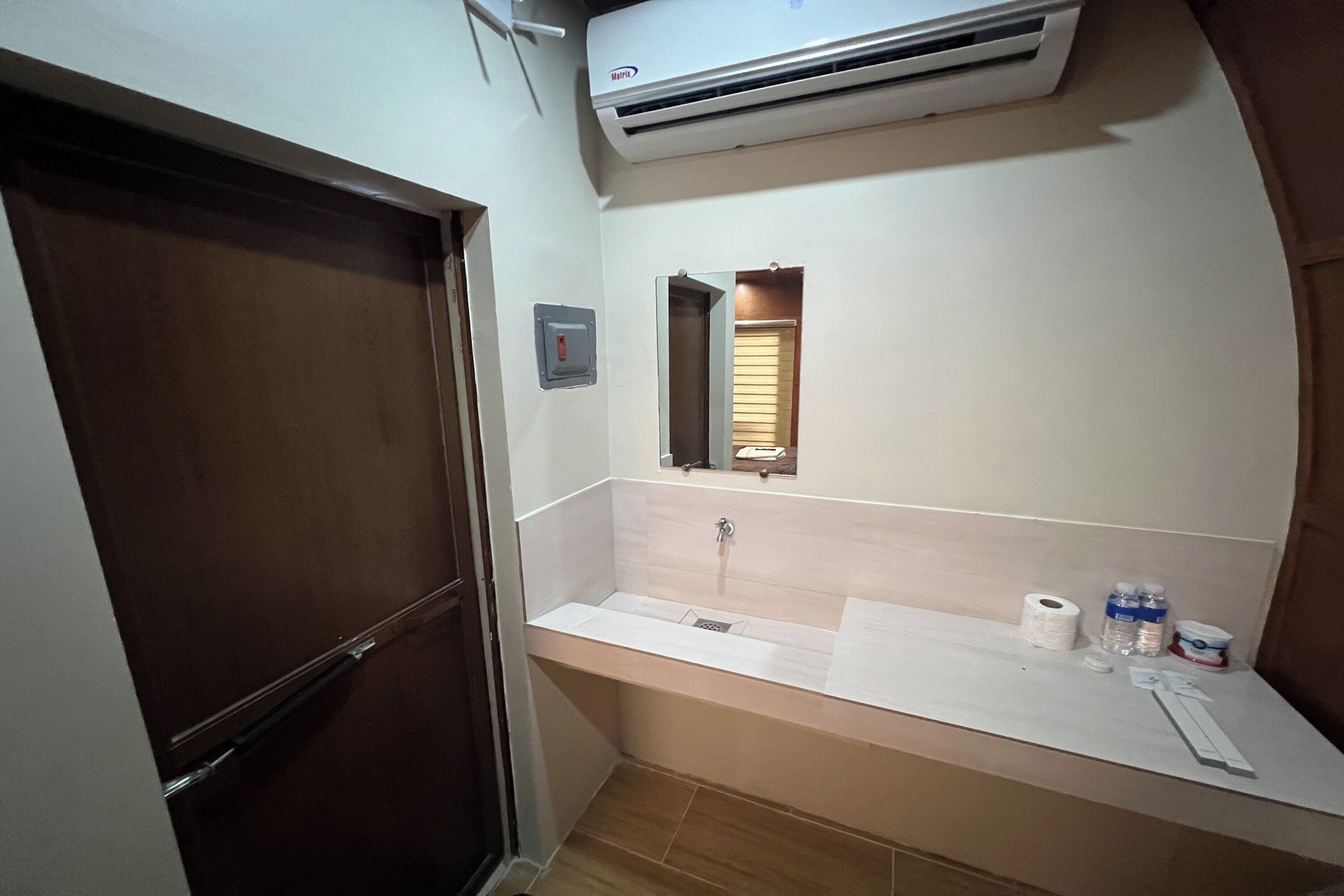 A bathroom with a sink, mirror, and toilet.