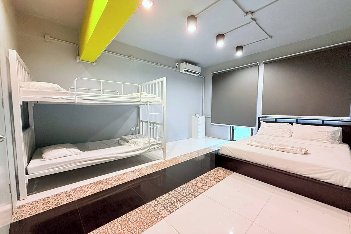 A hotel room with bunk beds, a large window, and a modern design.