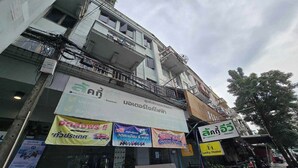 A multi-story building with various signs and advertisements.