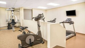 A fitness center with cardio equipment including a treadmill, elliptical, and stationary bike.